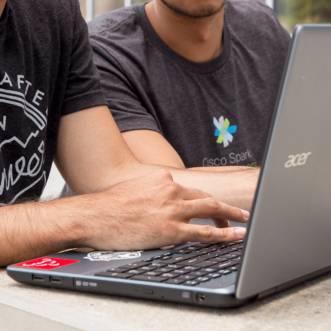 Close-up of student's hands on laptop