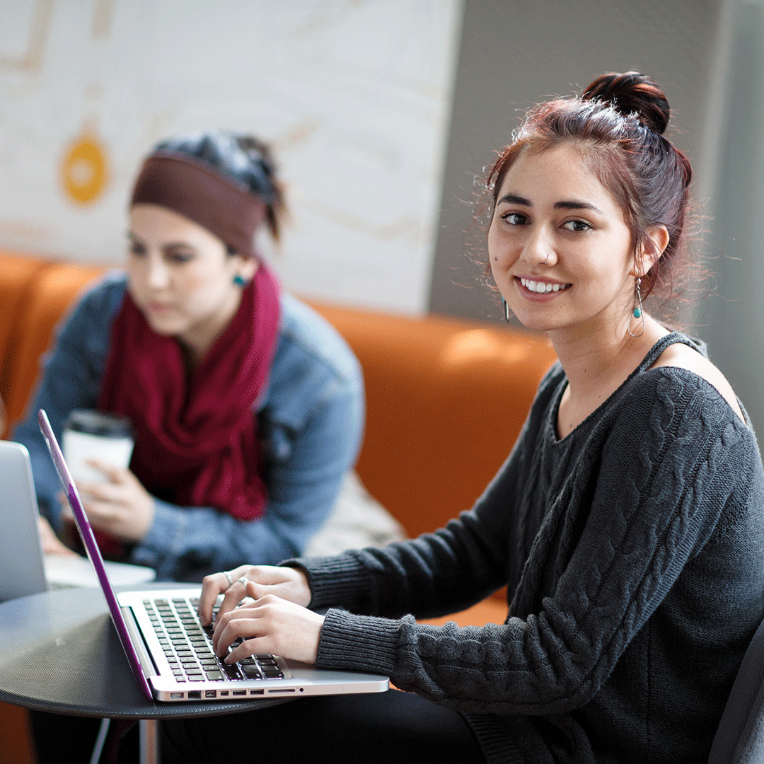 Student studies on laptop in a study group