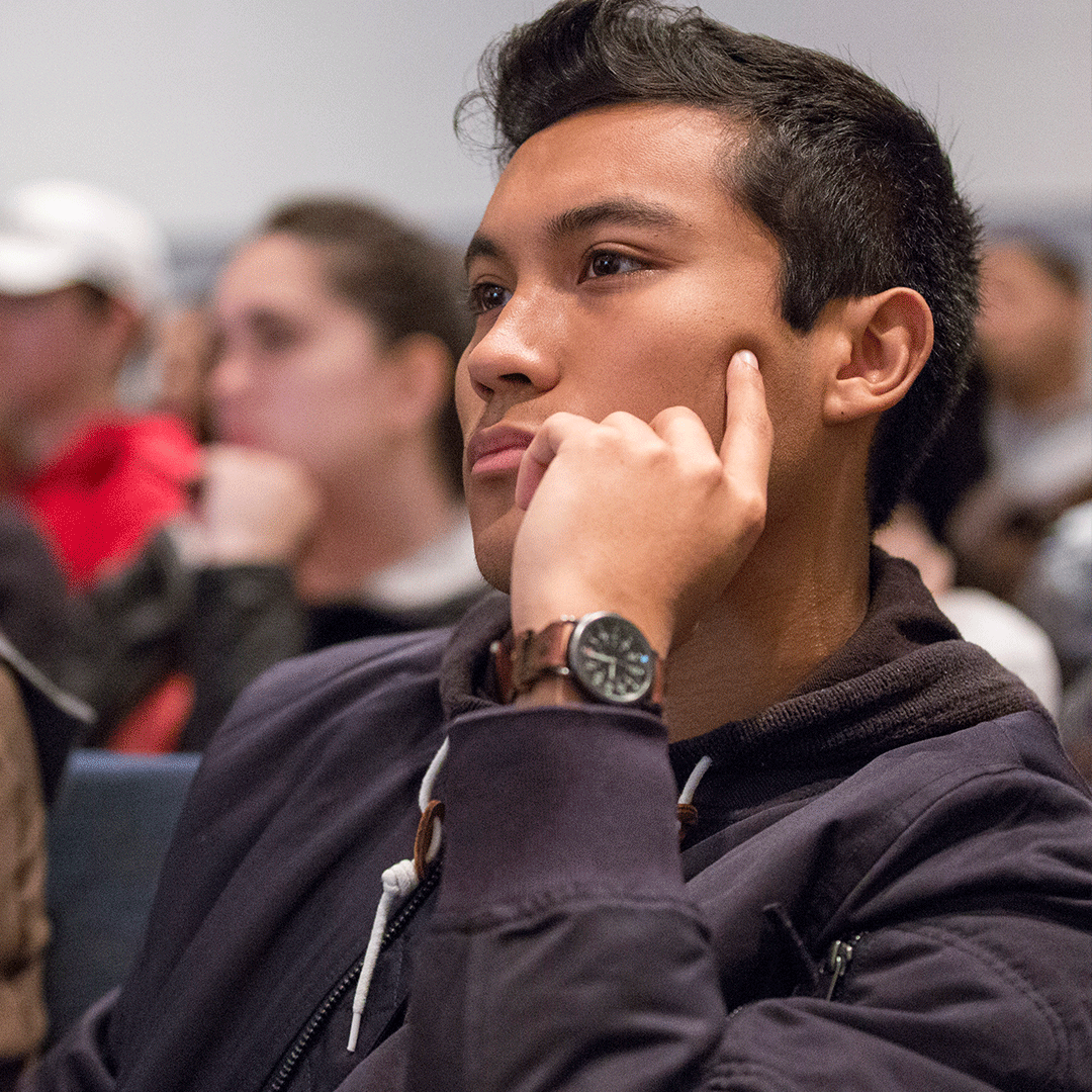 Student listens in a thinking pose