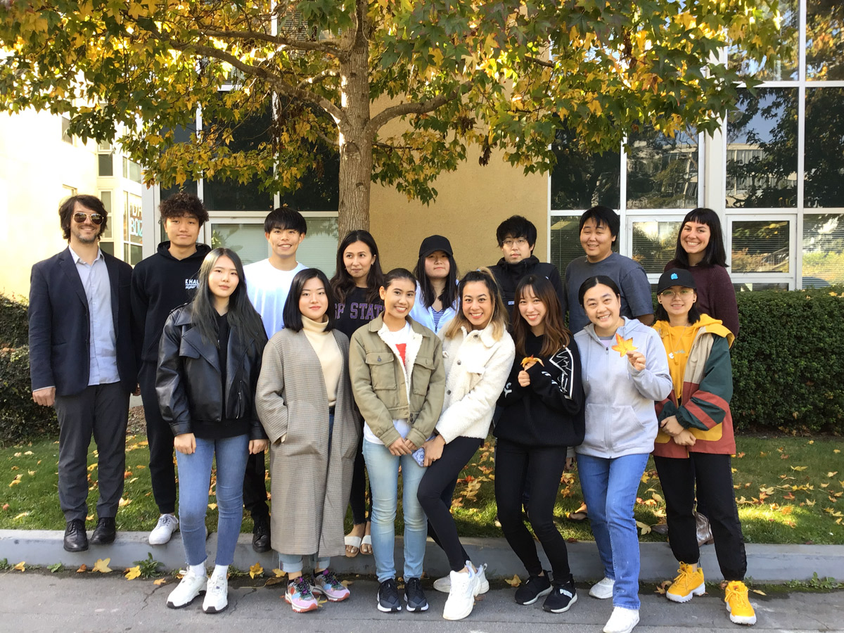 American Language Institute students under a fall tree