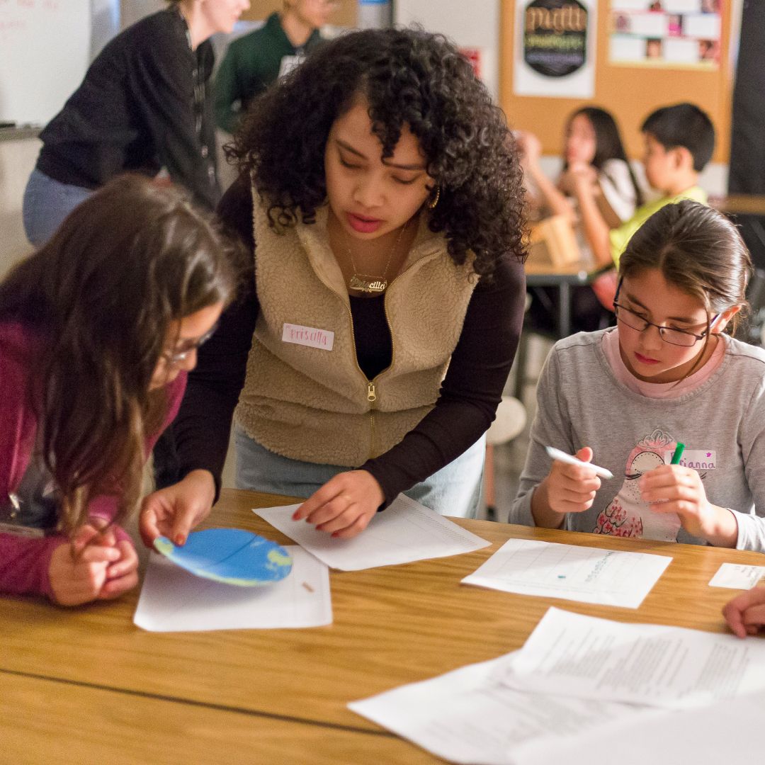 Climate educator helping students in class