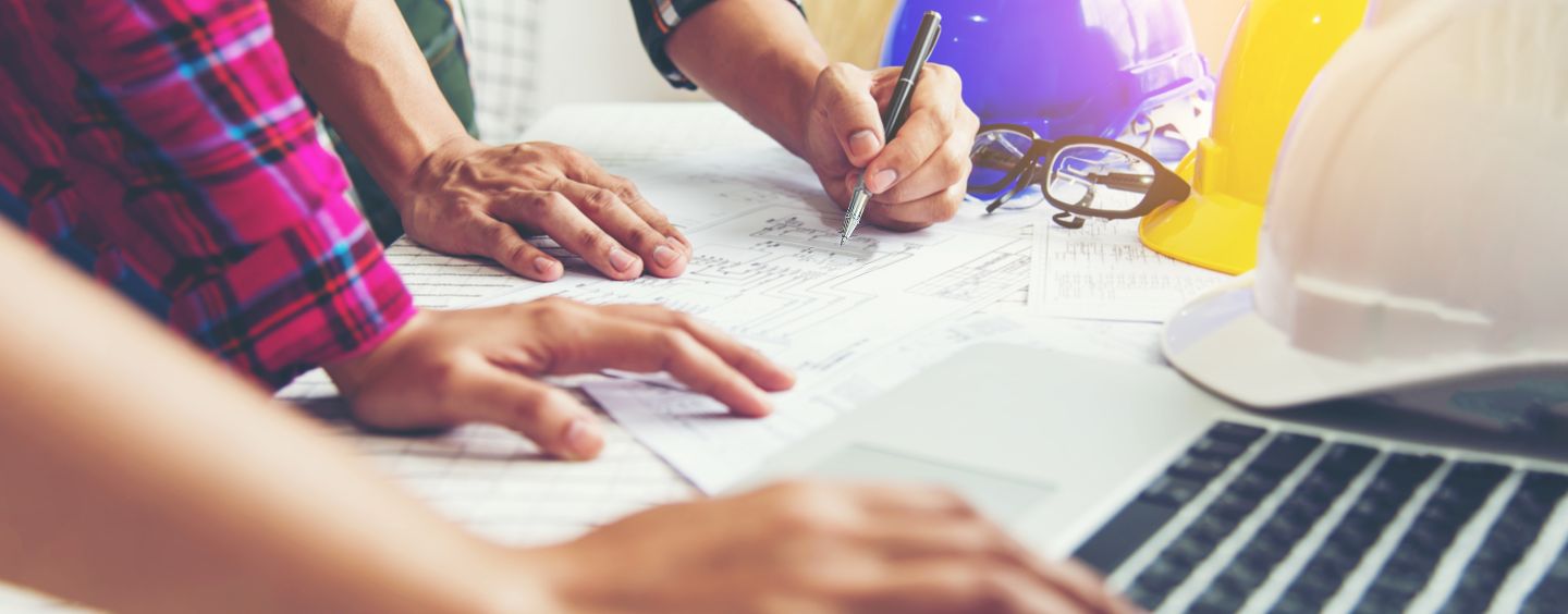 Construction Professionals work with plans and laptop