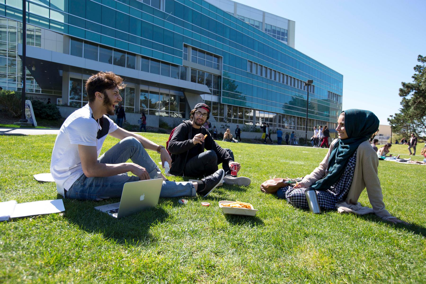 Trio of students on the grass