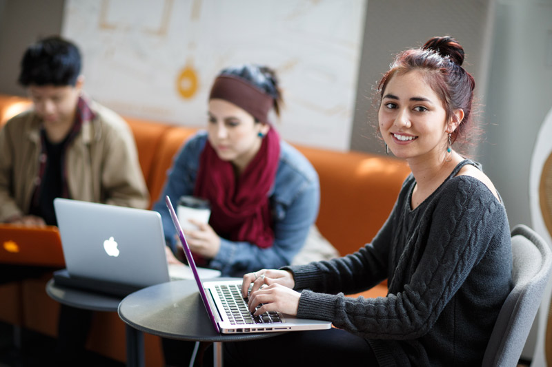 Student on laptop takes online English teacher training