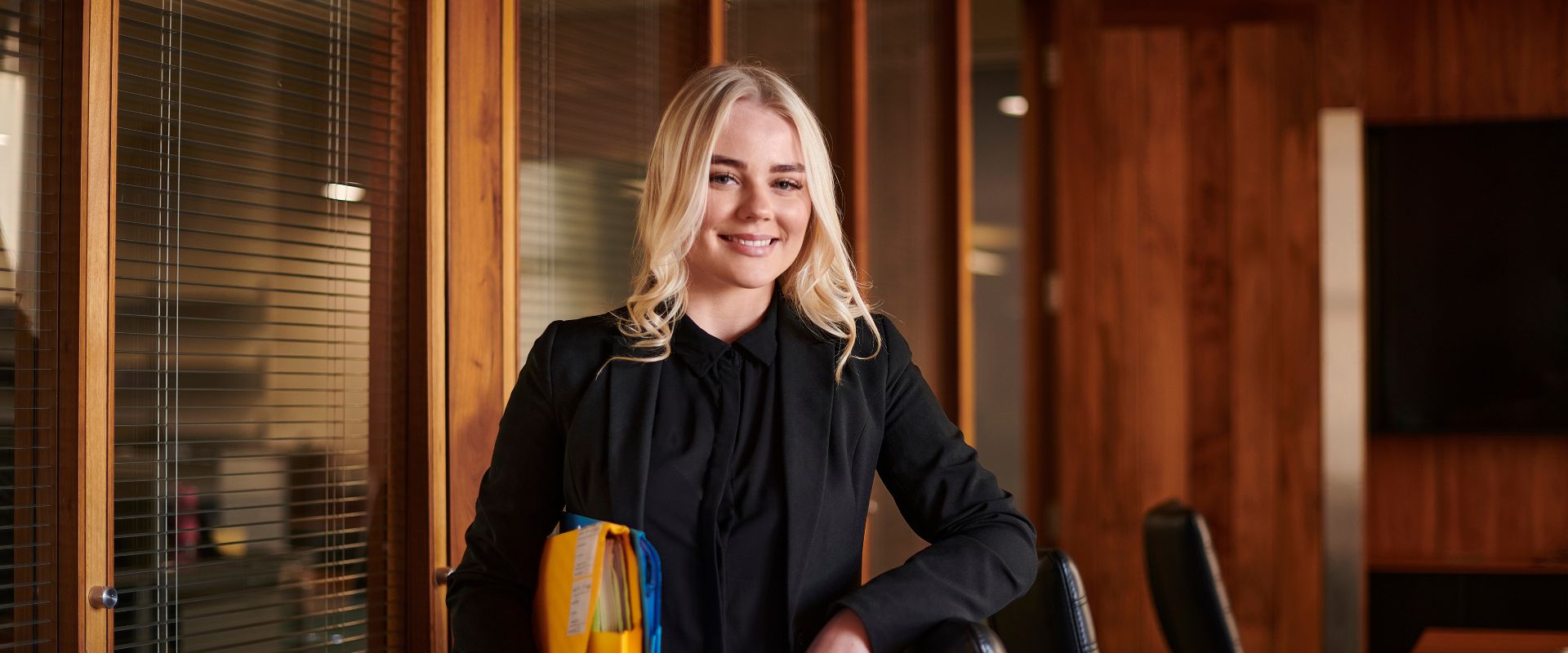 Paralegal professional standing in a legal conference room