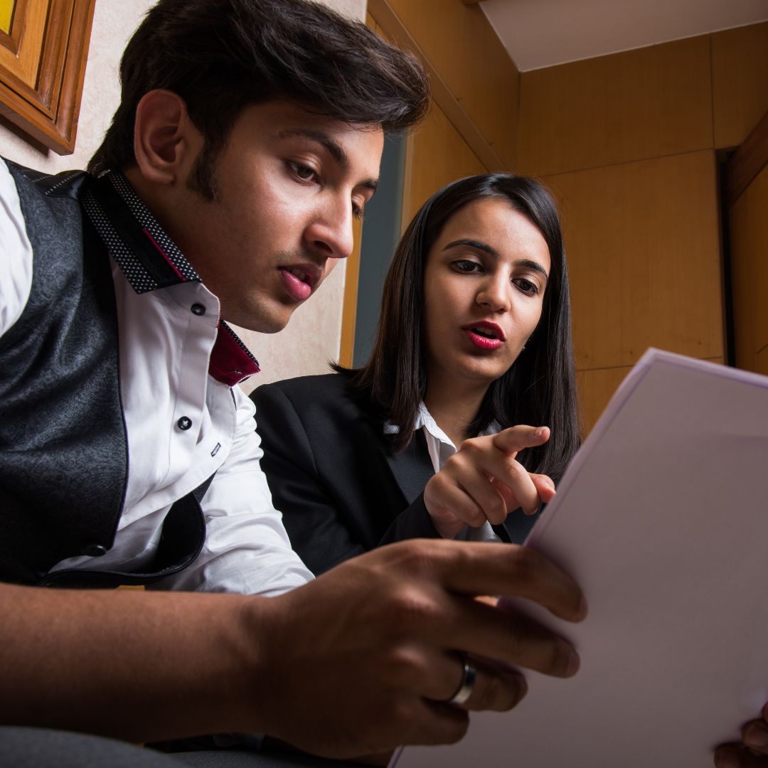 Paralegals discuss a document