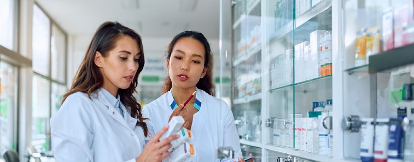 Two pharmacists read medication instructions