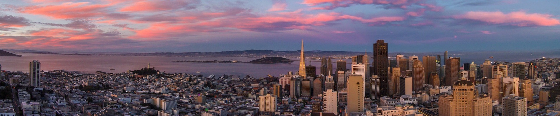 San Francisco cityscape at sunset, with pink clouds