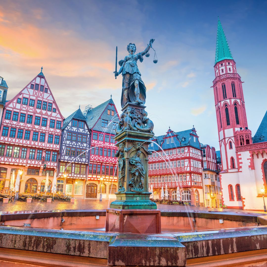 Frankfurt old town statue and buildings, with pink clouds before sunset