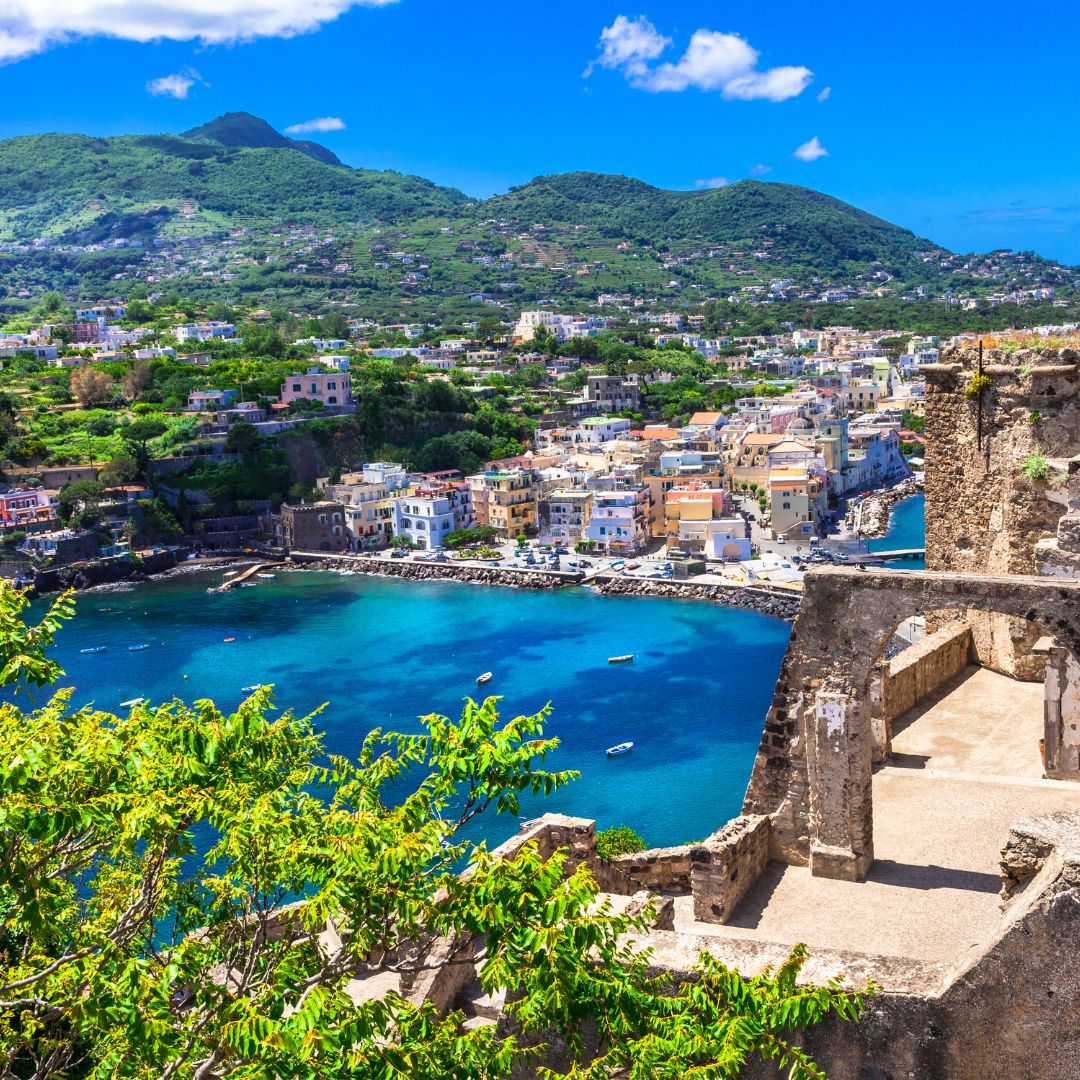 Ruins, water and a town in Ischia, Italy