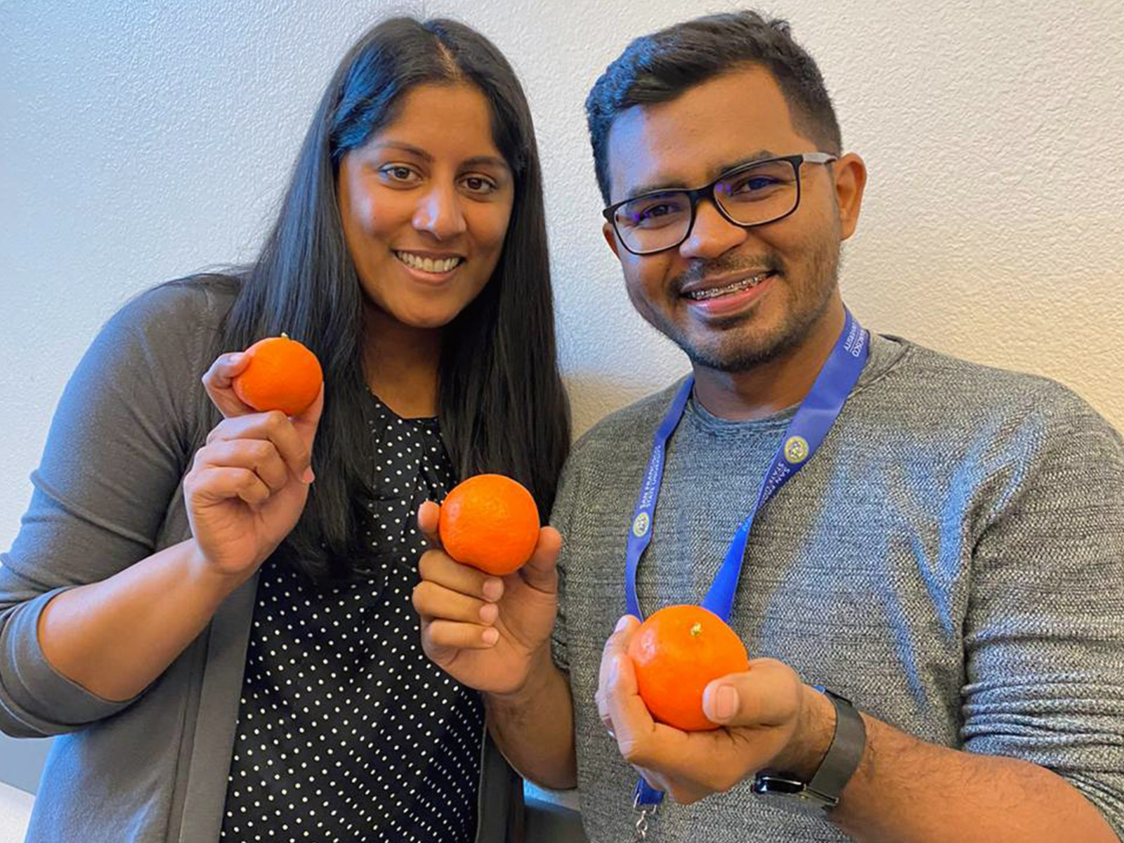 K-12 teacher trainees holding mandarins