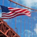 USA flag in front of the Golden Gate Bridge