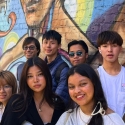 International student sin front of a Jackie Chan dragon mural in Chinatown