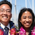 SF State graduates in leis and regalia at a marina