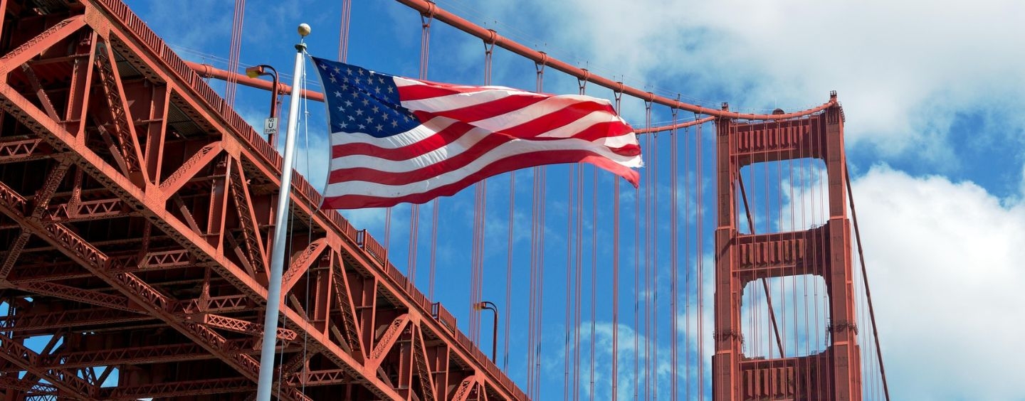 USA flag in front of the Golden Gate Bridge