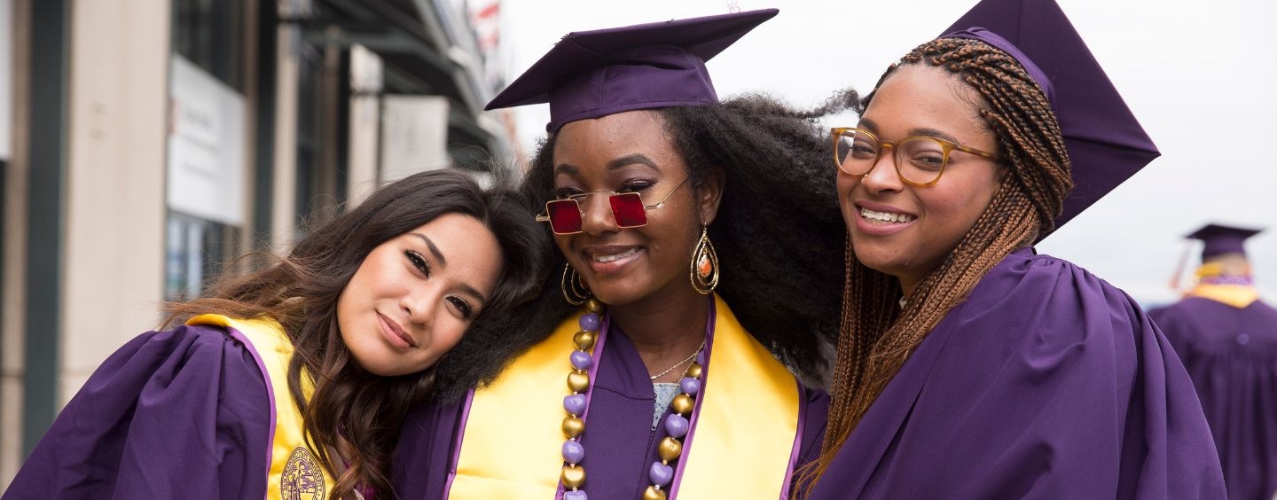 Three women graduates at Commencement