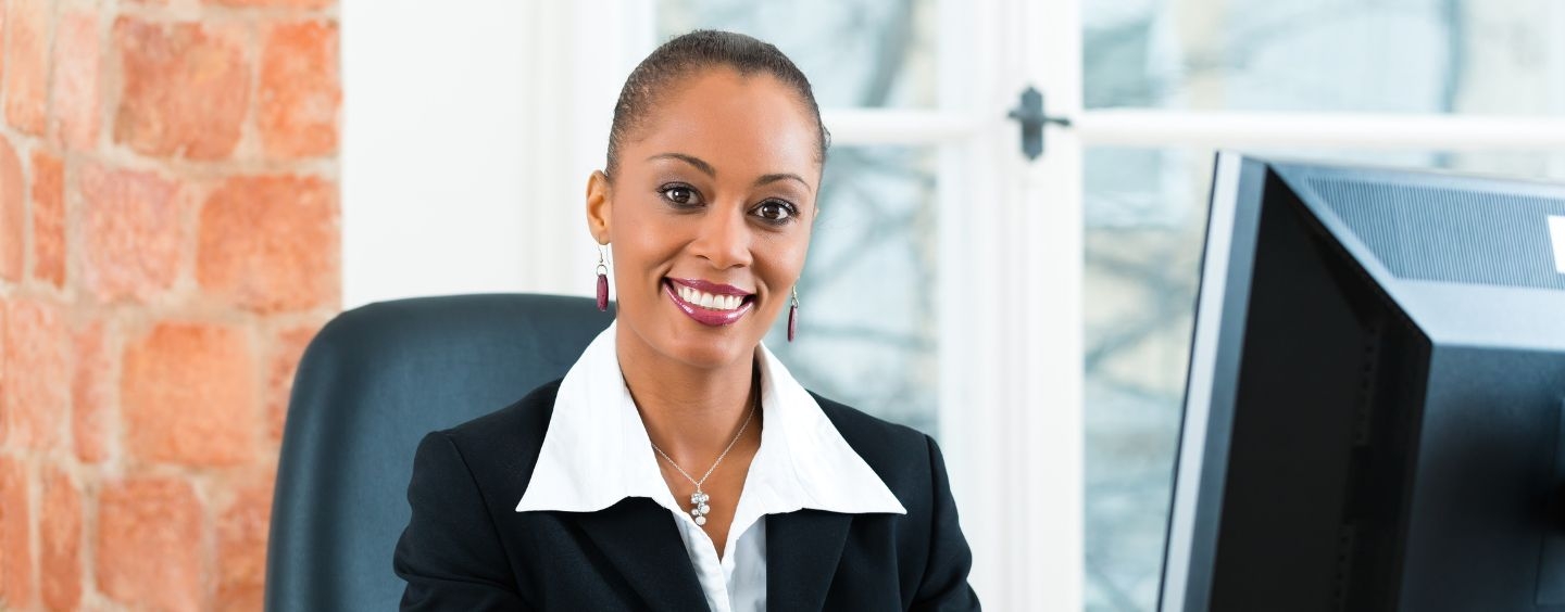 Paralegal smiles at her desk