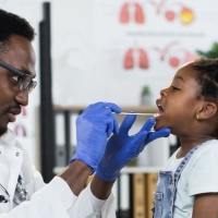 School nurse examines a student's throat