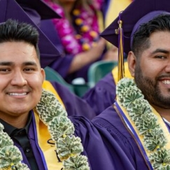 Business graduates wearing money leis at Commencement