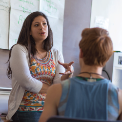 Student talks with professor in class