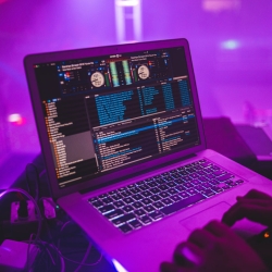 Laptop controlling purple lights and lasers