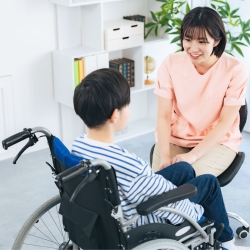 School nurse speaks with student in a wheelchair