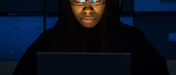 Ethical Hacker student studying in the dark