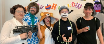 International students and staff in Halloween costumes
