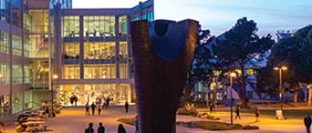 View overlooking the sculpture and library where students walk are walking.