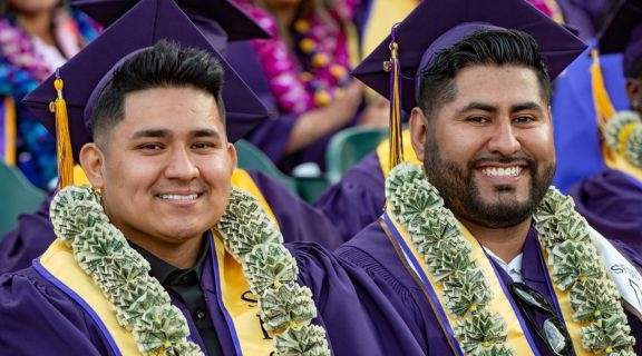 Business graduates wearing money leis at Commencement