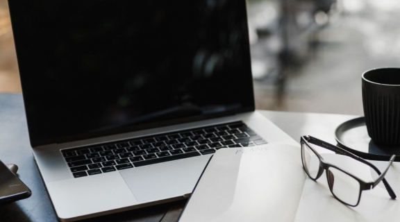 Laptop, notebook, glasses and coffee